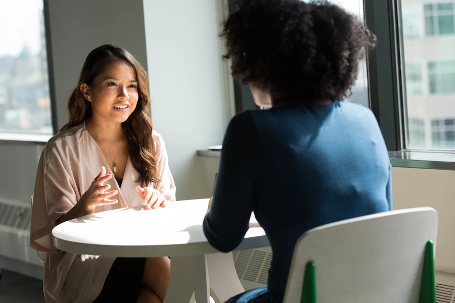 Two women having a conversation across a table