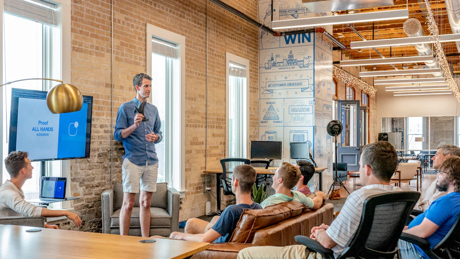 Colleagues listening to a presentation in an open office